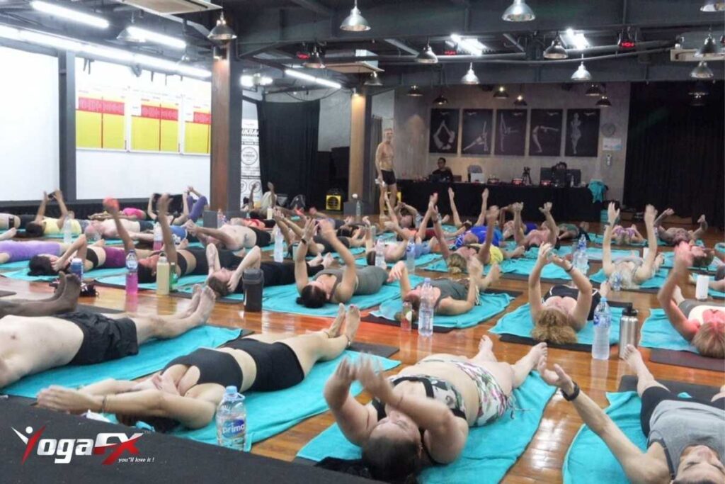 Bikram yoga Camel Pose hip forward technique for lower back pain showing correct thoracic extension versus lumbar compression error