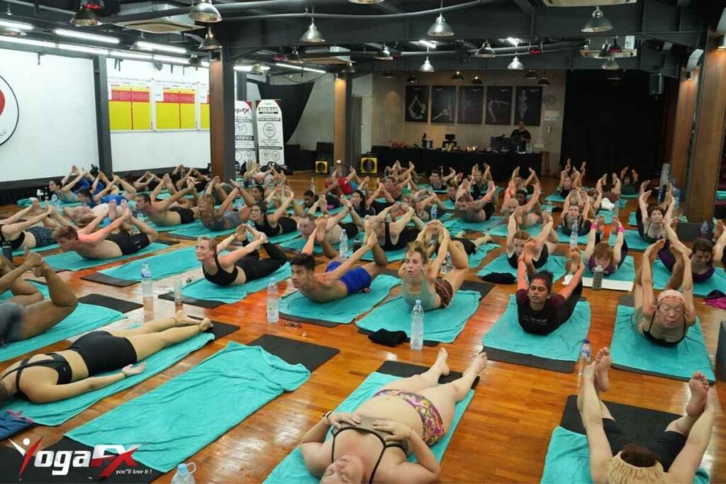 Bow Posture Bikram yoga kicking mechanics showing feet kicking back and up away from body while arms hold fixed grip point
