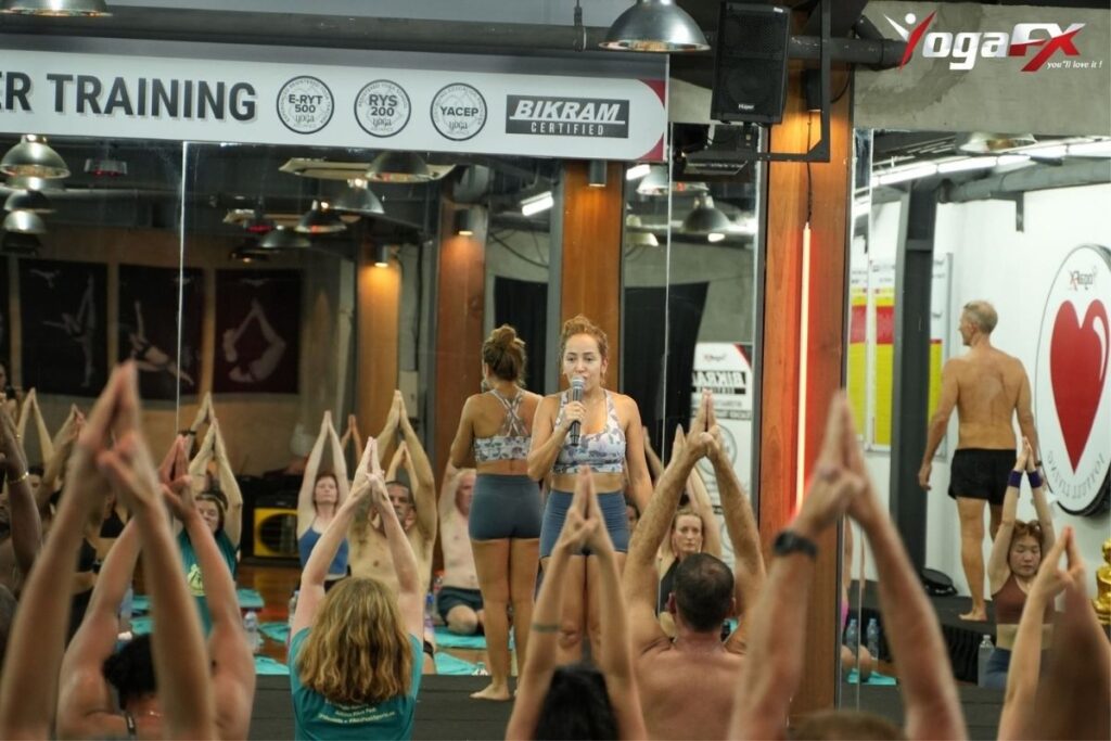 Certified RYT 200 yoga teacher leading class showing income potential from Bikram yoga teaching career in 2026