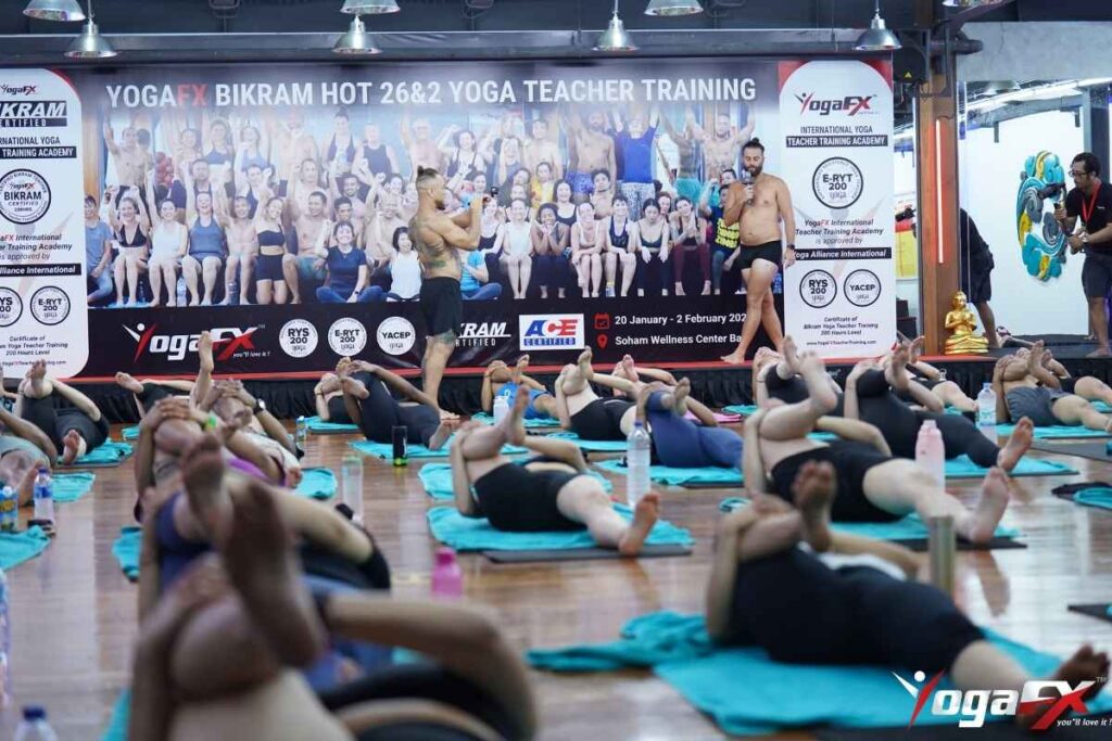 Newly certified yoga instructor leading first Bikram yoga class after completing YogaFX teacher training in Bali
