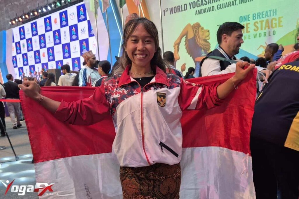 Ivara Candra Kartika YogaFX graduate holding gold and bronze medal at World Yogasana Sport Championship 2026 representing Indonesia