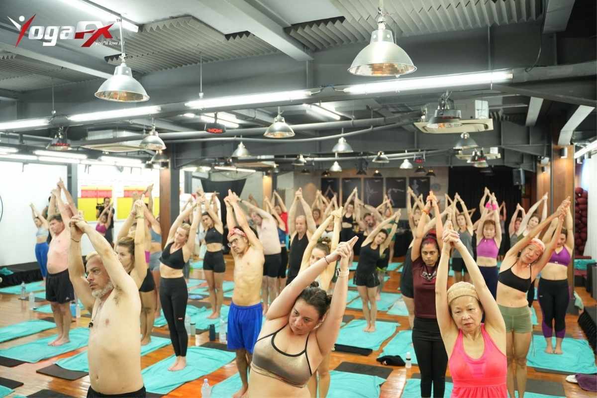Student holding Half Moon pose during the standing series of a Bikram yoga class, the segment most first-timers find hardest
