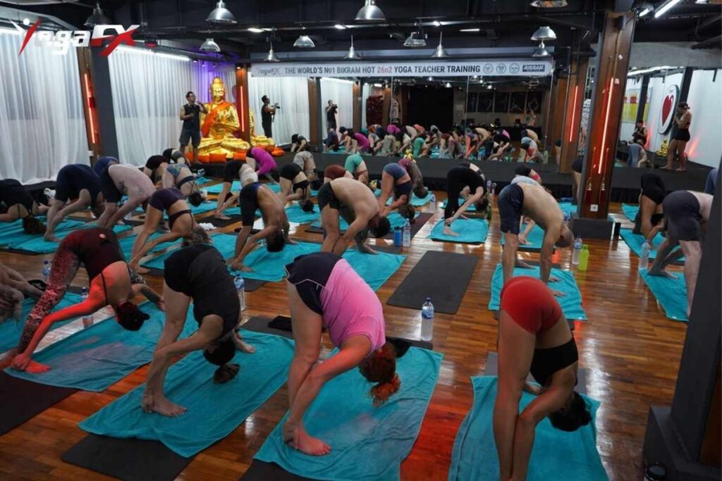 Yoga mindset in Bikram hot yoga showing practitioner maintaining focus during standing balance series in YogaFX Bali 40 degree heat environment