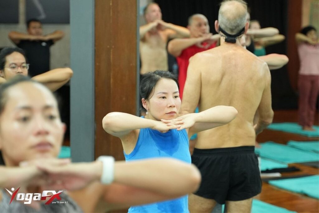 Students in a YTT (yoga teacher training) course practicing poses