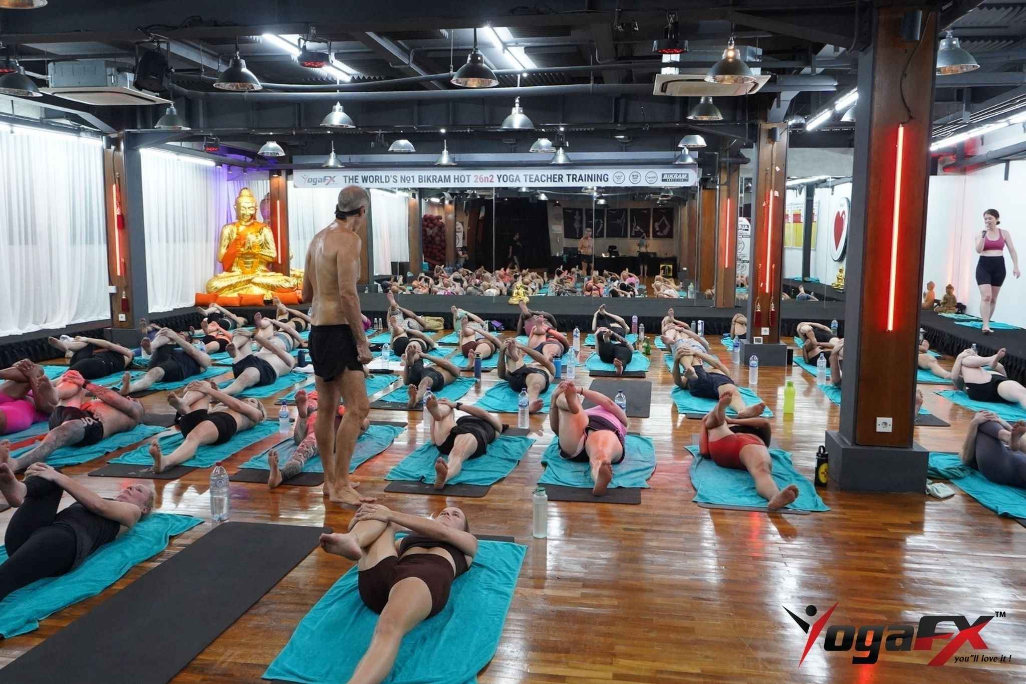 Yoga studio owner standing in front of their own studio