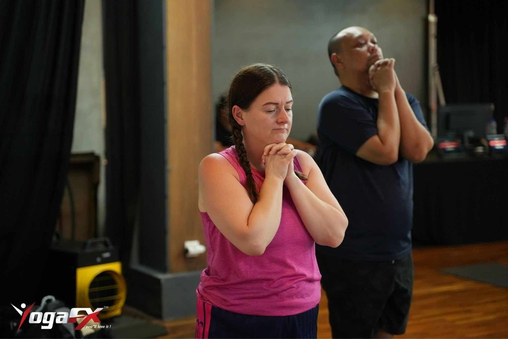 Practitioner focused during a heated Bikram yoga class