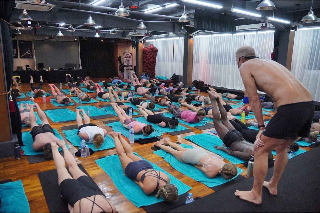Six-day hot yoga teacher training intensive in Bali with students practicing the Bikram Hot 26&2 sequence in a naturally heated studio in Seminyak.