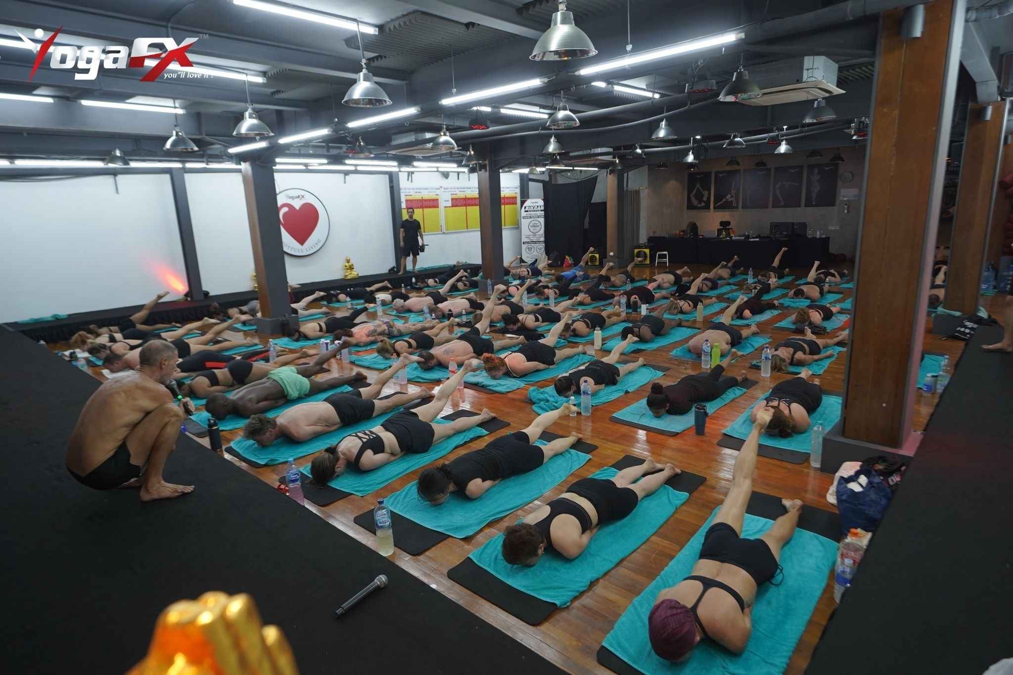 Hot yoga teacher trainees earning their hot yoga certification in natural tropical heat at the YogaFX teacher training in Seminyak, Bali
