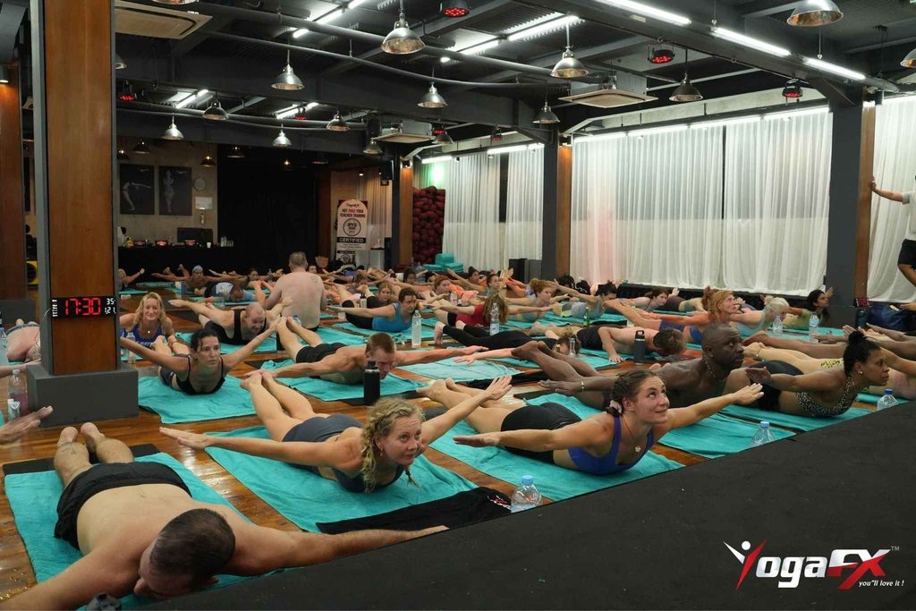 Student practicing a posture during an Original Hot Yoga teacher training class in a naturally heated studio in Bali, Indonesia