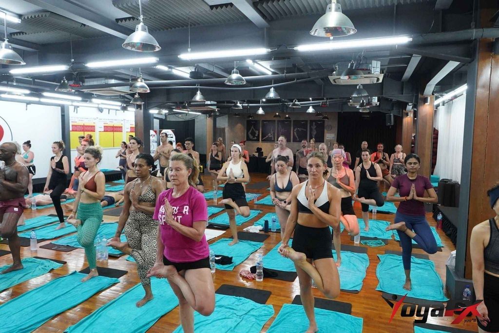 New RYT 200 graduate teaching a community yoga class